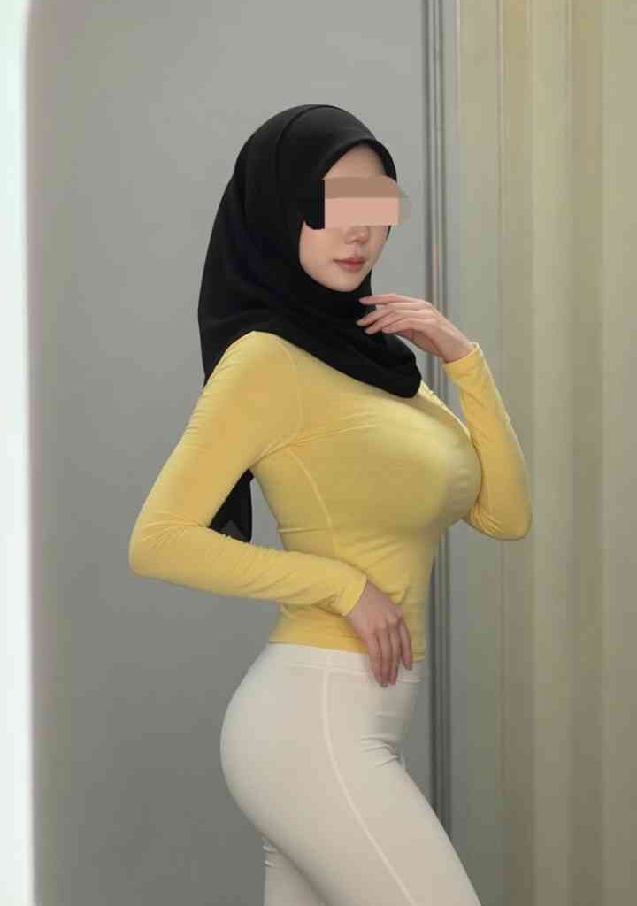 Young Malay woman in hijab and yellow top, KL